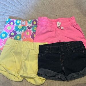 Lot of 5 girls pull on shorts.